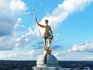 independent man on top of the statehouse with the sky as a backdrop