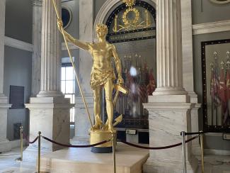 independent man statue inside statehouse on pedistal