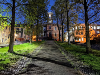 Foot path to the front of the building, lined with trees